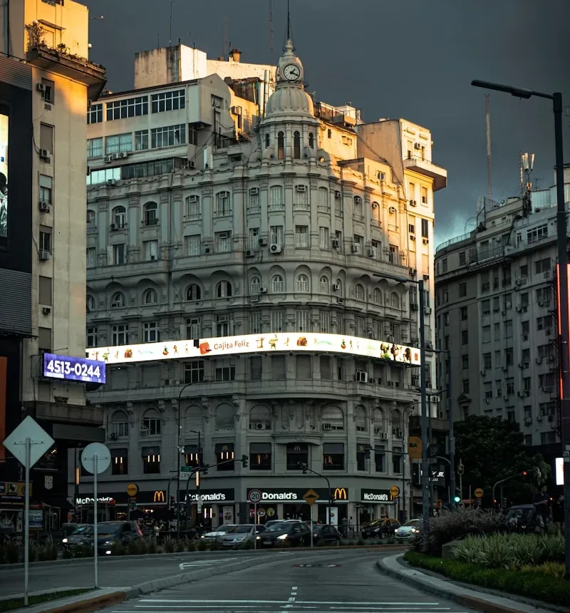 cars on road near brown concrete building during nighttime